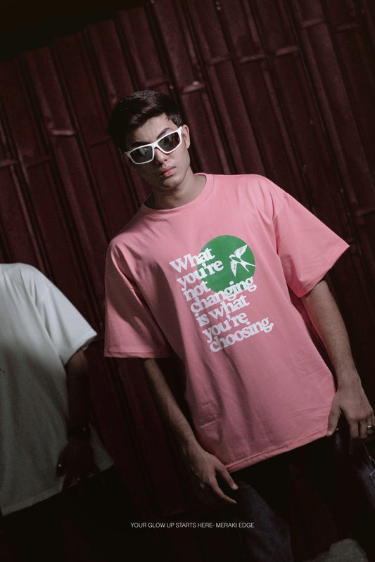 T-shirt in rose gold color featuring ‘what you’re not changing is what you’re choosing’ print