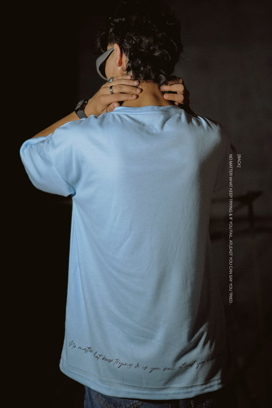 T-shirt in sky blue color featuring ‘Anything is possible if you’ve got enough nerve’ print