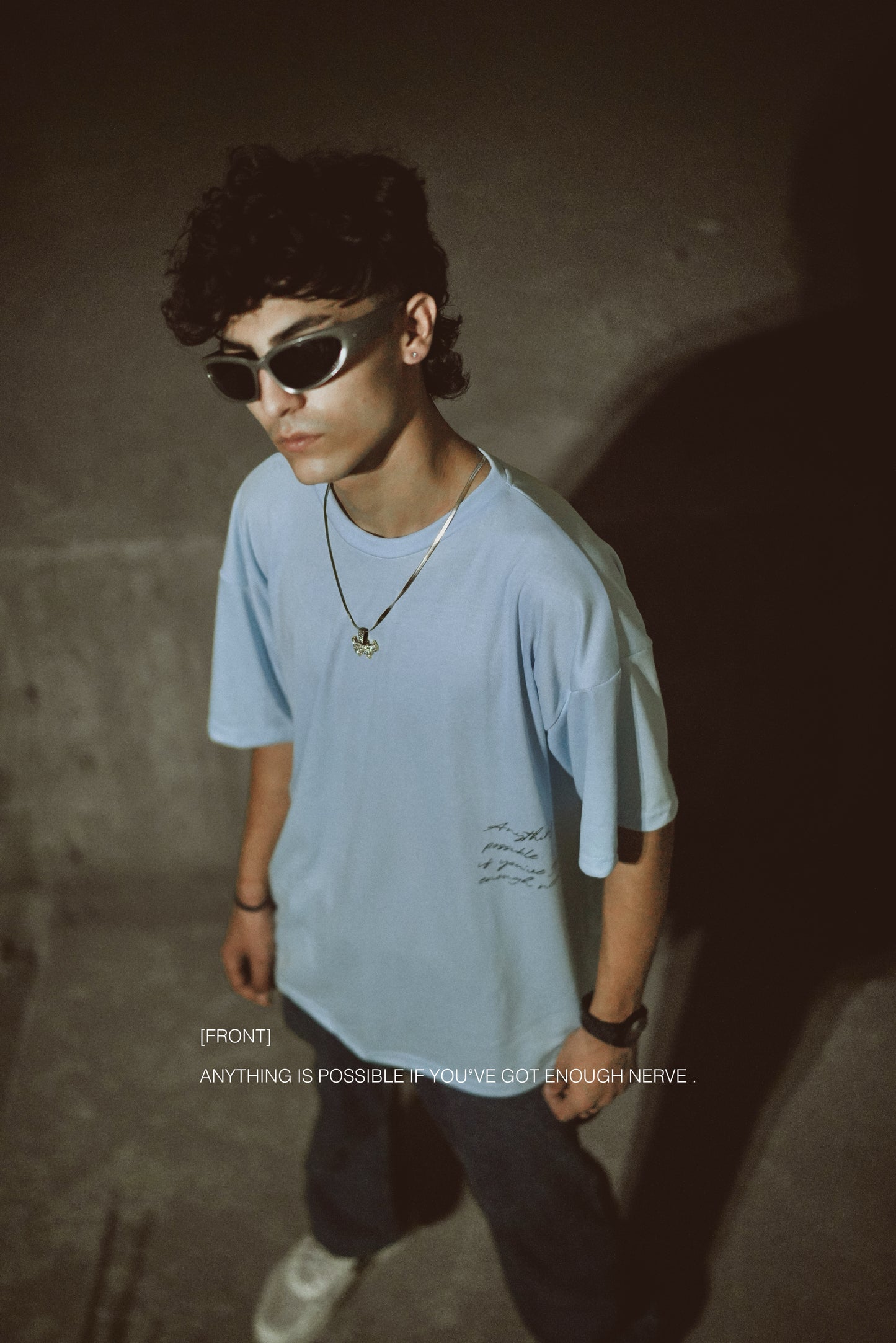 T-shirt in sky blue color featuring ‘Anything is possible if you’ve got enough nerve’ print